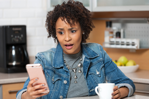 Frustrated woman looking at mobile phone